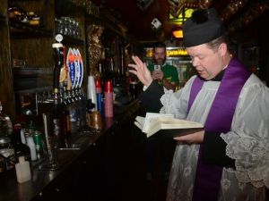 priest blesses beer